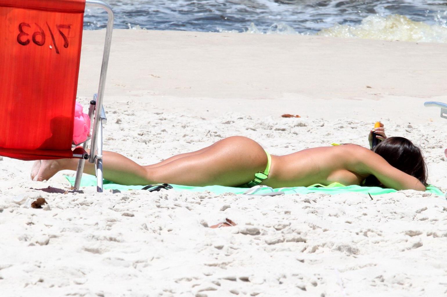 10P Nicole Bahls showing off her boobs  ass while tanning topless on a beach in Rio