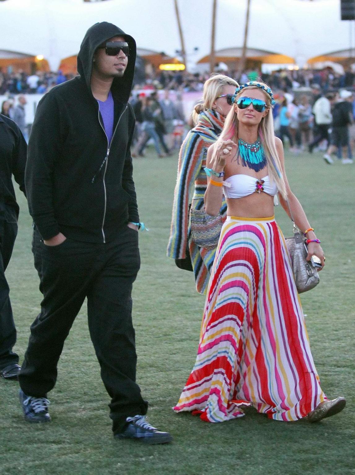 10P Paris Hilton wearing bikini top  skirt at Coachella Music Festival