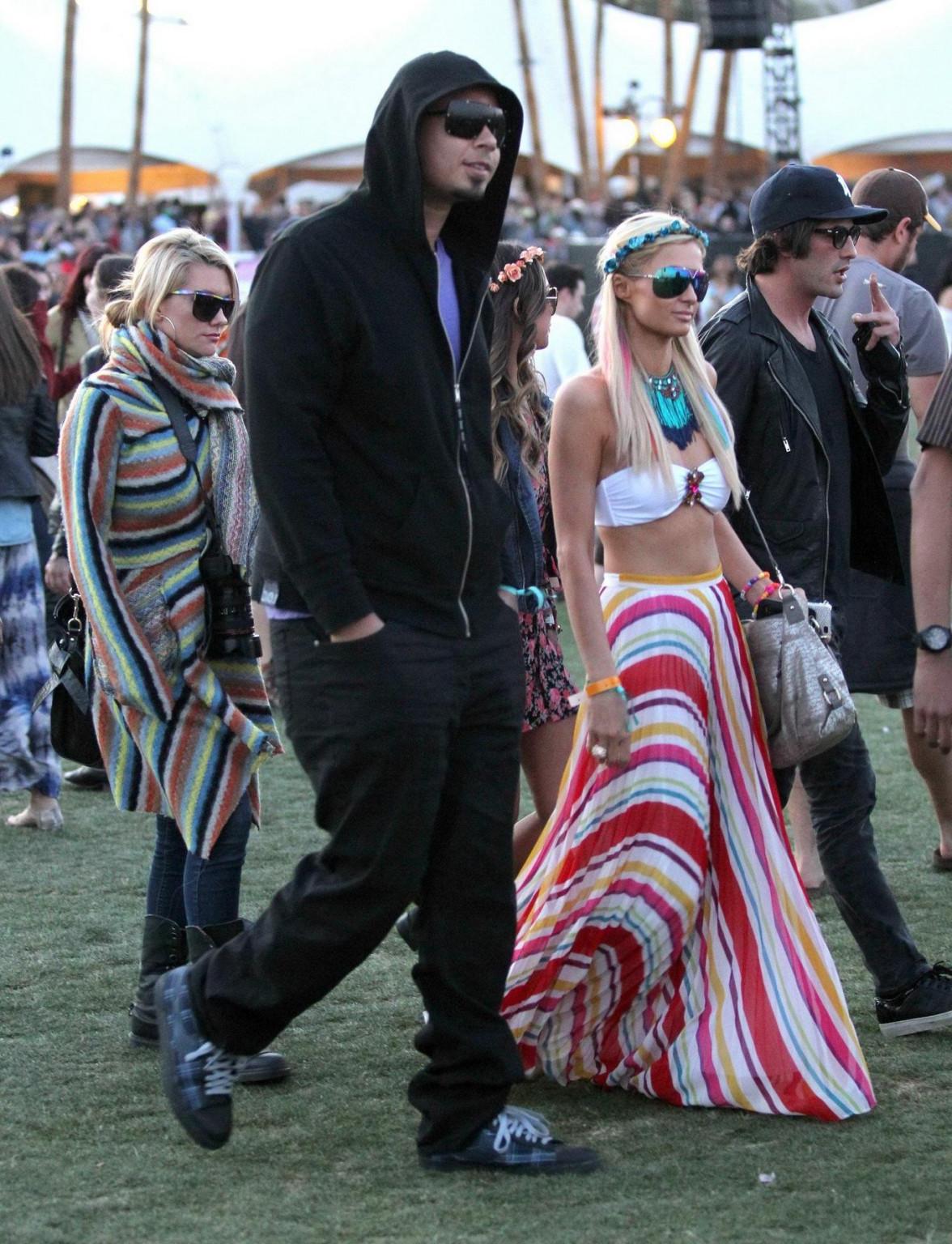 10P Paris Hilton wearing bikini top  skirt at Coachella Music Festival