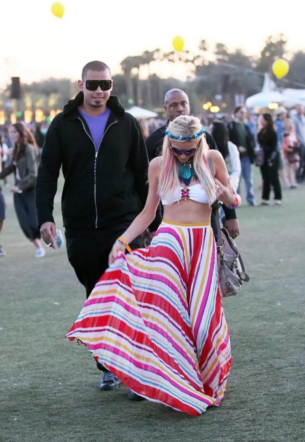 10P Paris Hilton wearing bikini top  skirt at Coachella Music Festival