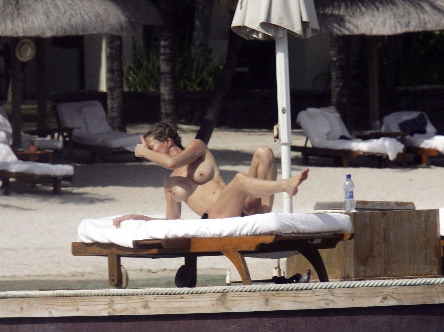 16P Karen Mulder tanning topless on a beach in Mauritius