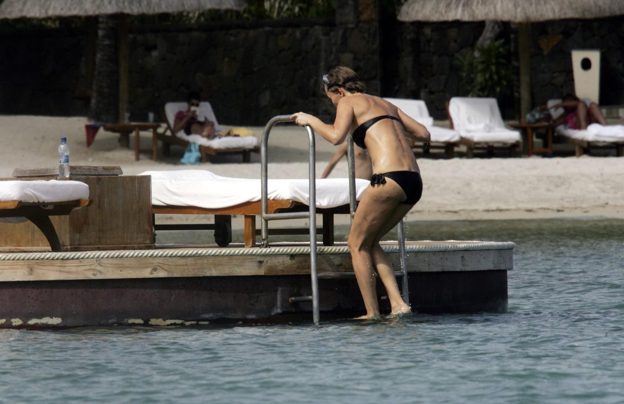 16P Karen Mulder tanning topless on a beach in Mauritius
