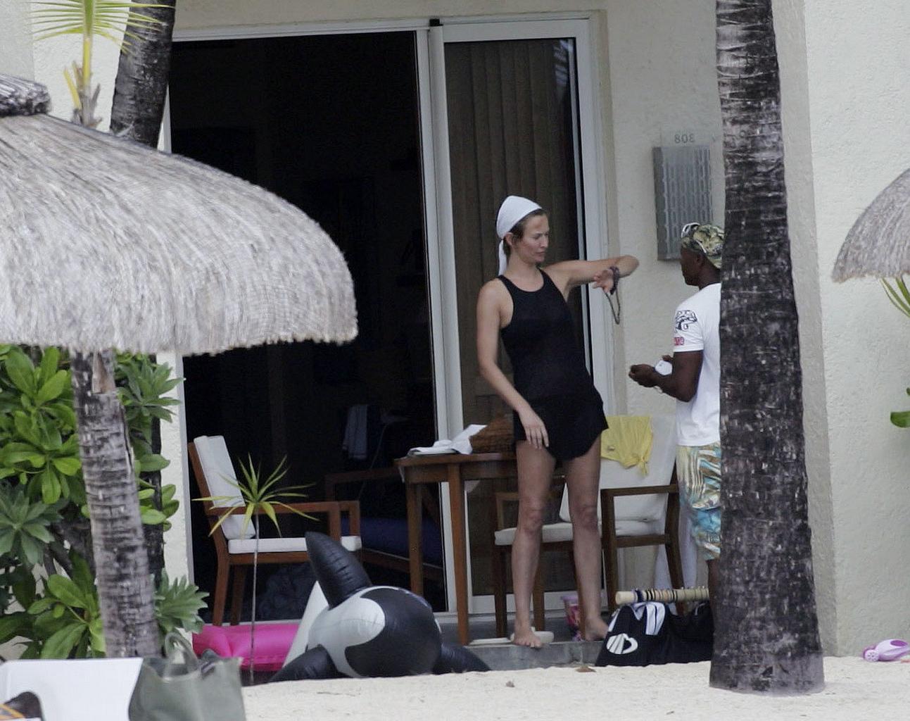 16P Karen Mulder tanning topless on a beach in Mauritius