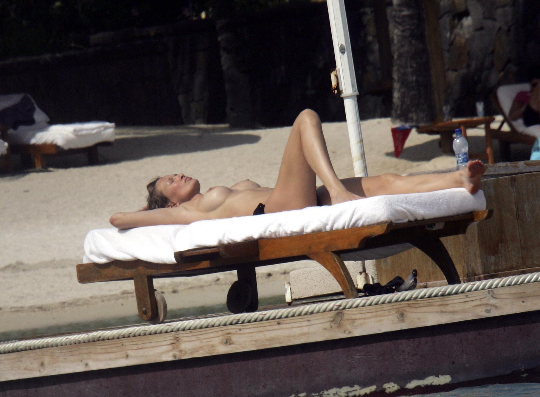 16P Karen Mulder tanning topless on a beach in Mauritius
