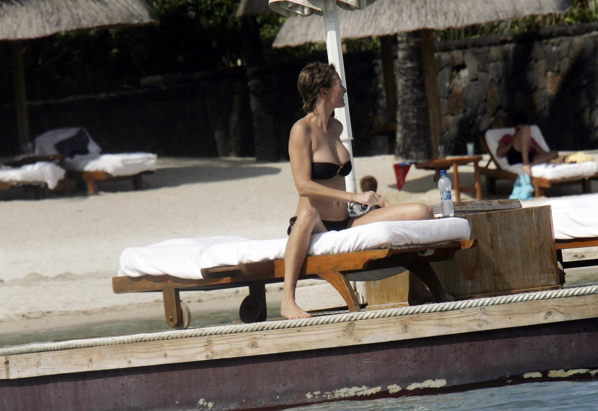 16P Karen Mulder tanning topless on a beach in Mauritius