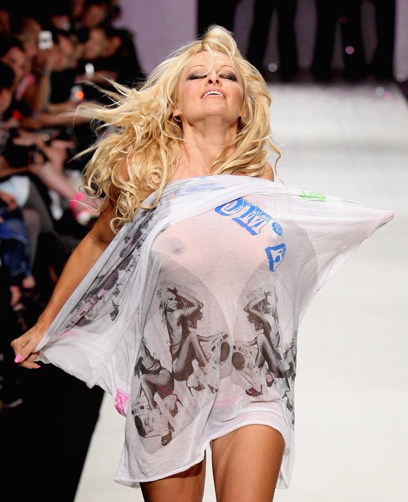 16P Pamela Anderson shows attractive topless on yacht