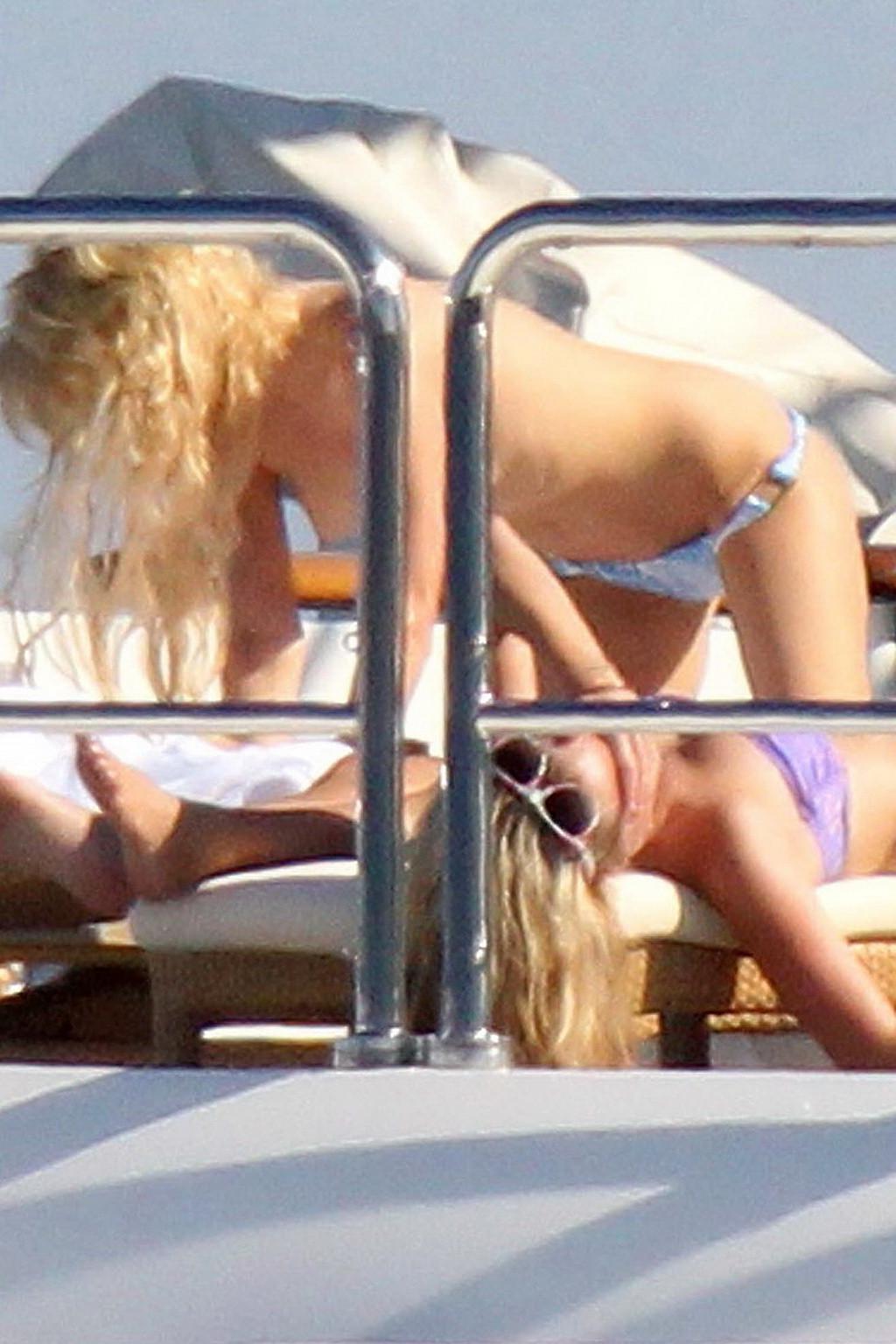 15P Paris Hilton topless showing off her small tits on a yacht in Italy