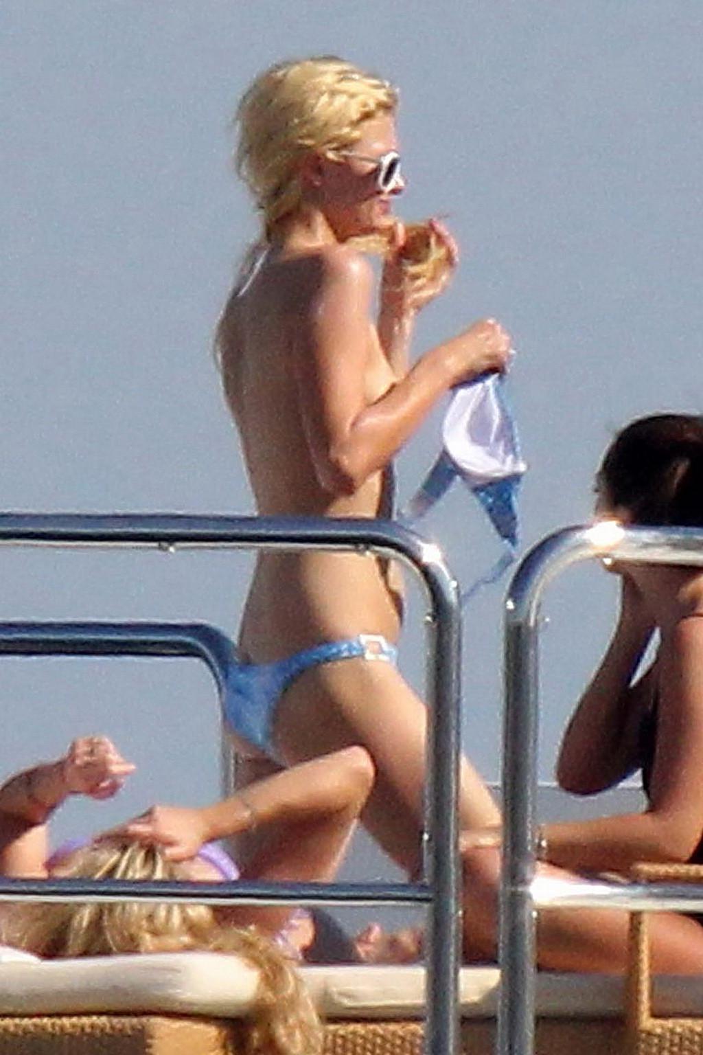 15P Paris Hilton topless showing off her small tits on a yacht in Italy