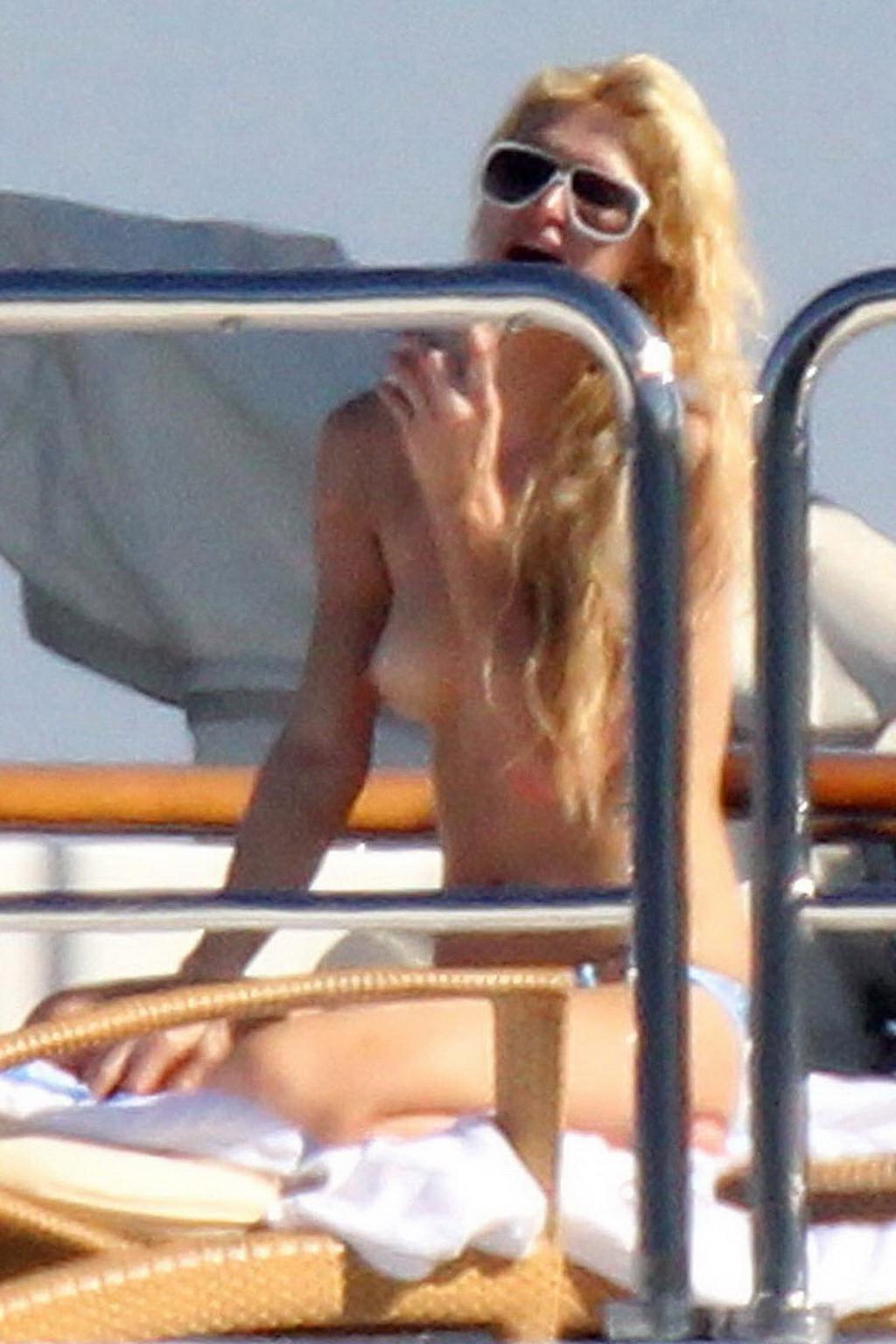 15P Paris Hilton topless showing off her small tits on a yacht in Italy