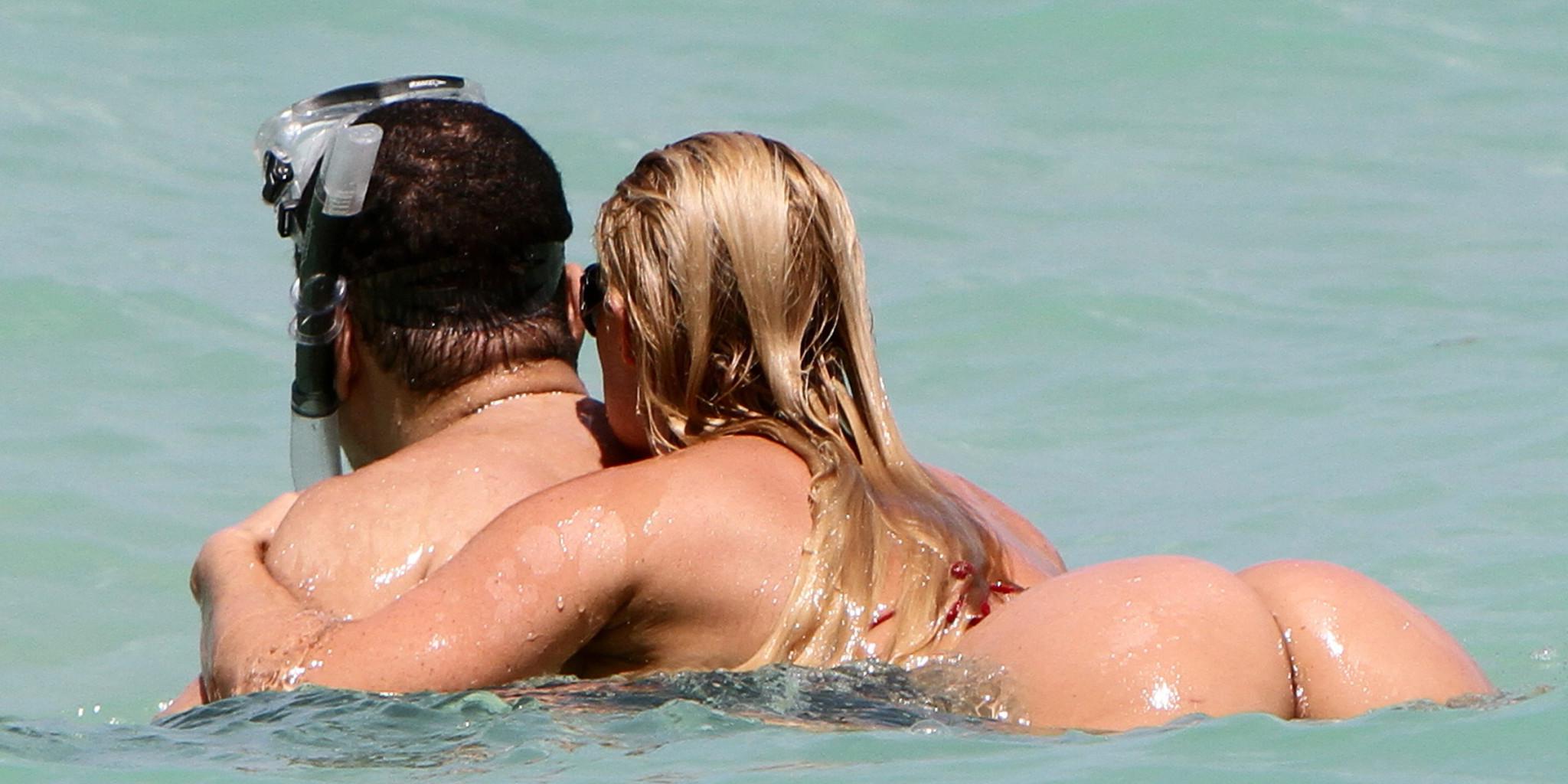 15P Nicole Coco Austin topless in red thong bikini bottom sunbathing on the beach in