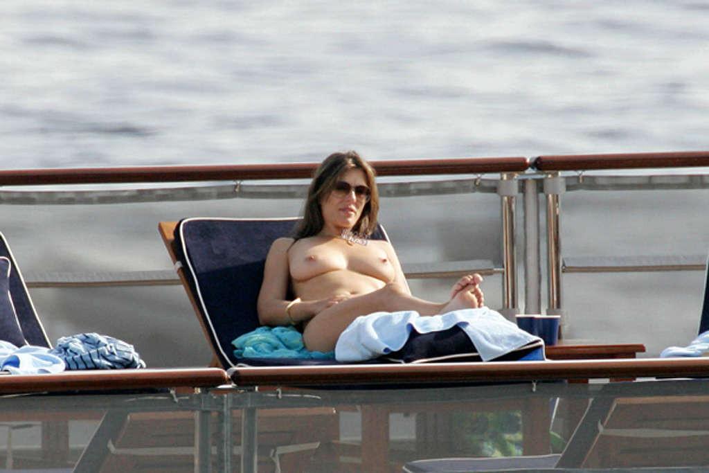10P Elizabeth Hurley leggy in mini skirt and topless on beach