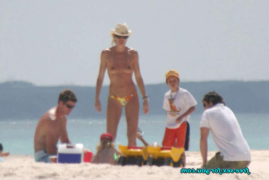 16P Elle Macpherson topless and leggy in black mini skirt