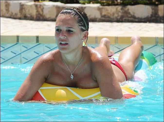 16P Danielle Lloyd posing in topless on pool paparazzi pictures