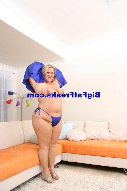 15P Busty chubby blonde woman stripping on the sofa