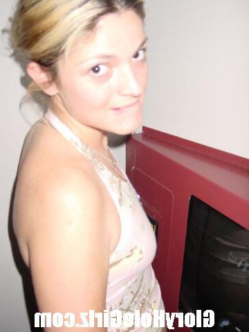 20P Hot babe sucking and stroking strangers cocks at gloryhole