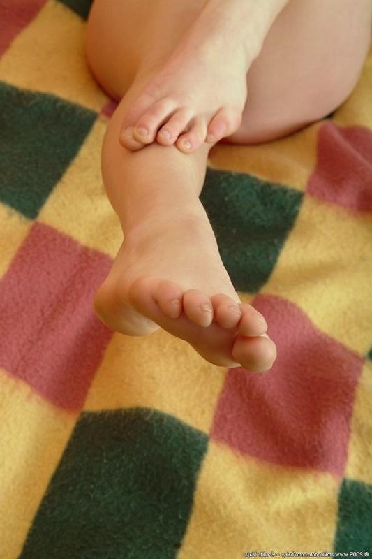 15P Nina lays back and shows off her lovely feet