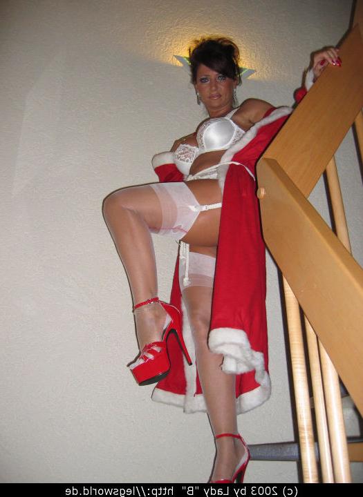 12P Leggy Santa lady B in white lingerie wearing long red coat