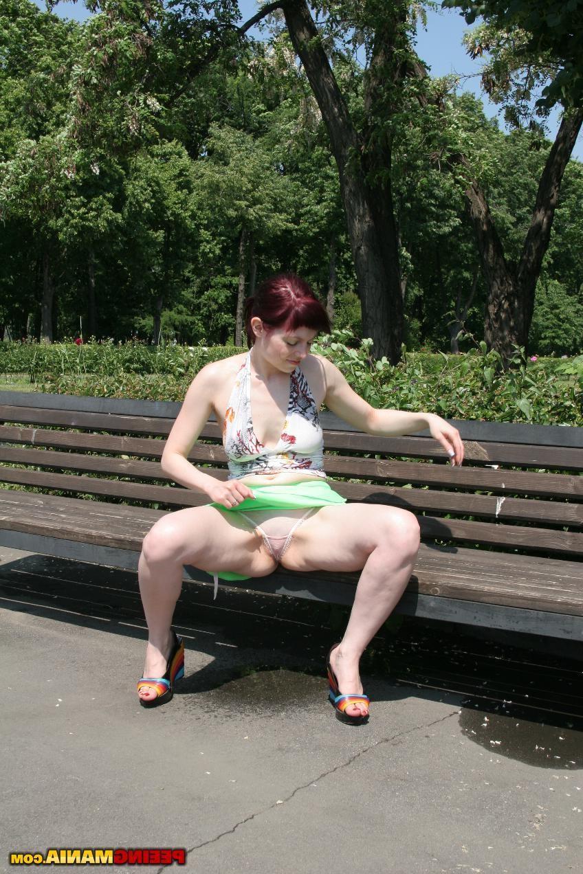 15P Redhead bitch spreads her legs and pees right in the panties outdoors