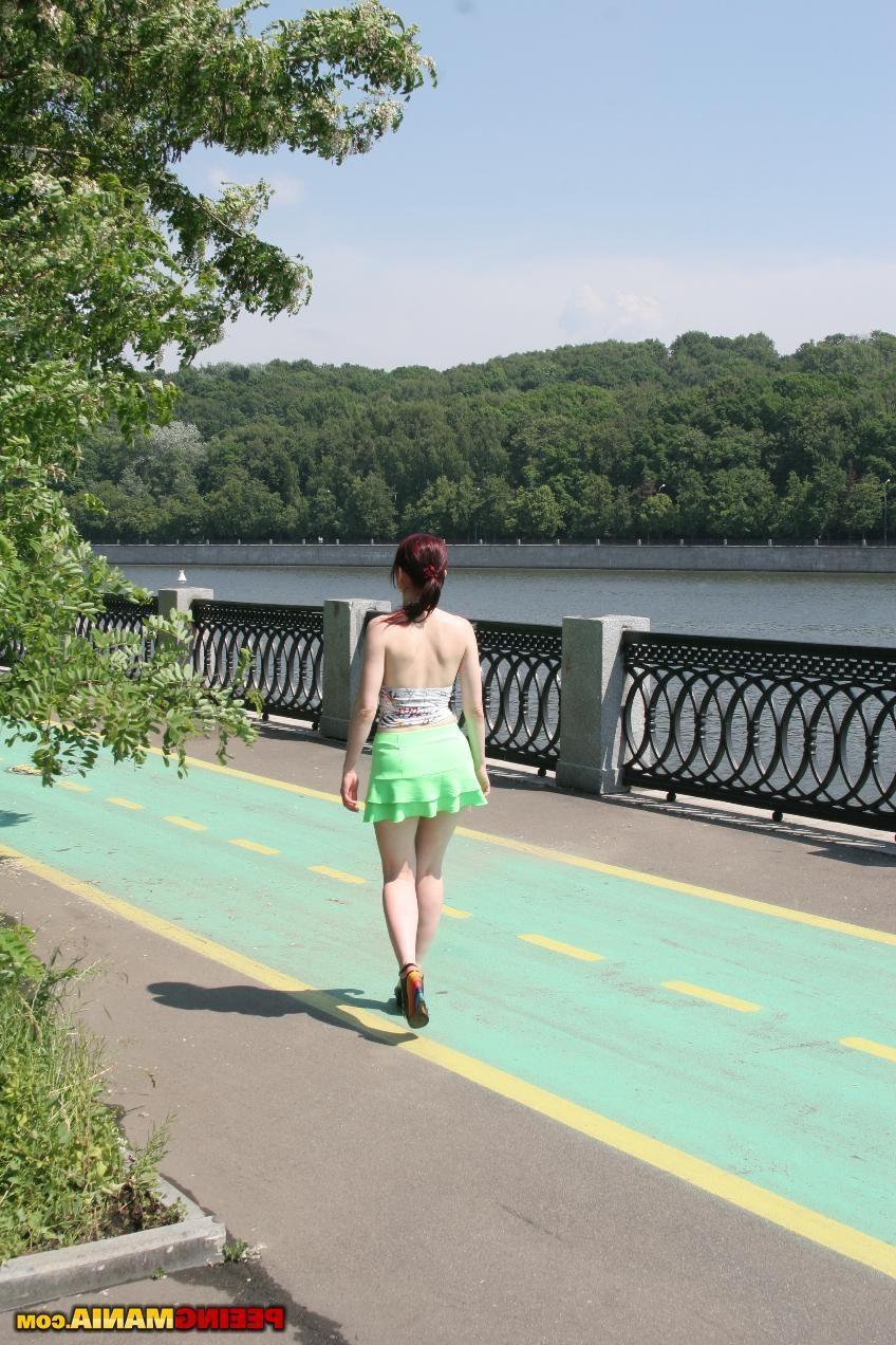 15P Redhead bitch spreads her legs and pees right in the panties outdoors