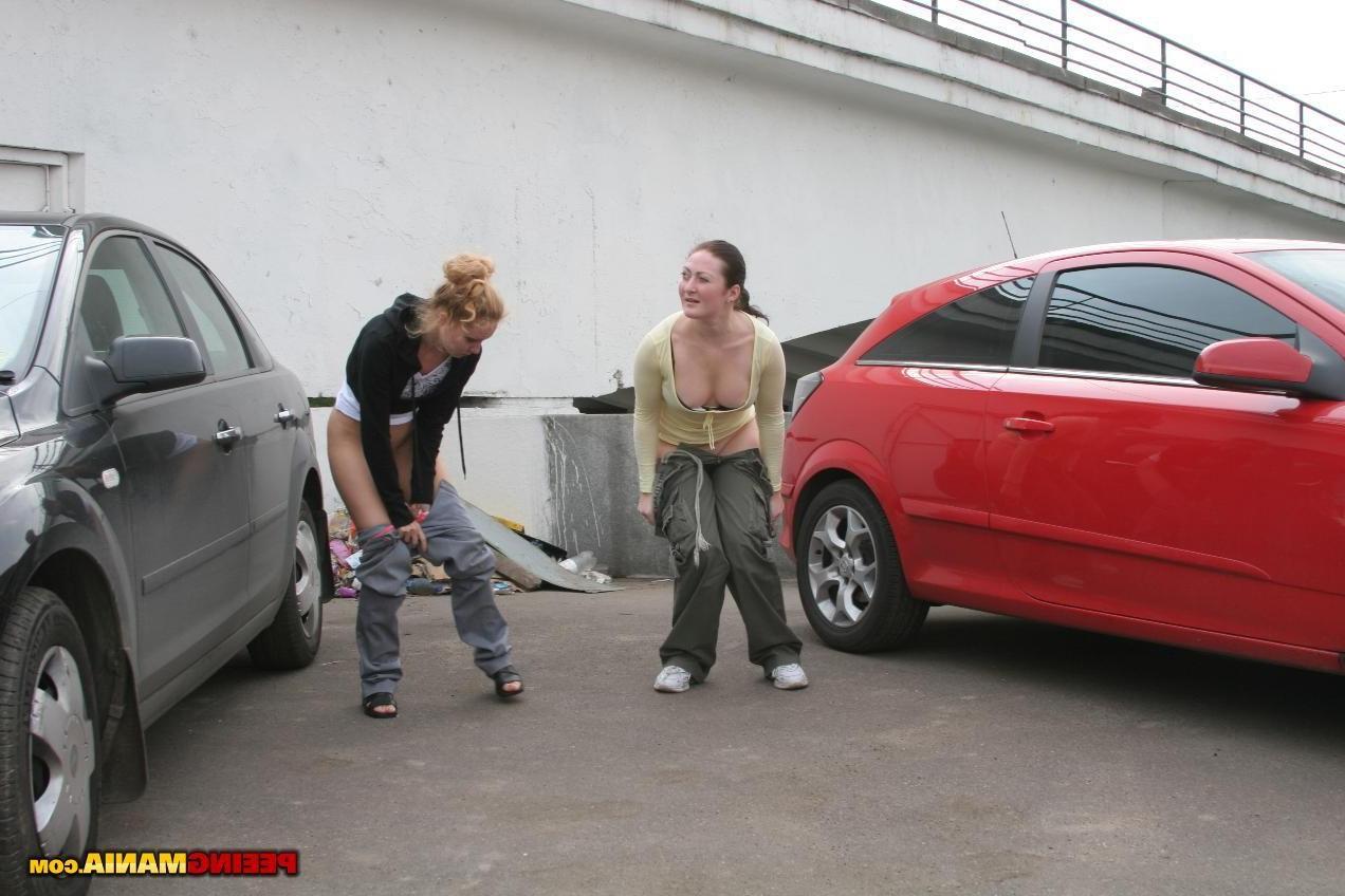 15P A couple of nasty squatted gals empty their bladders among the cars