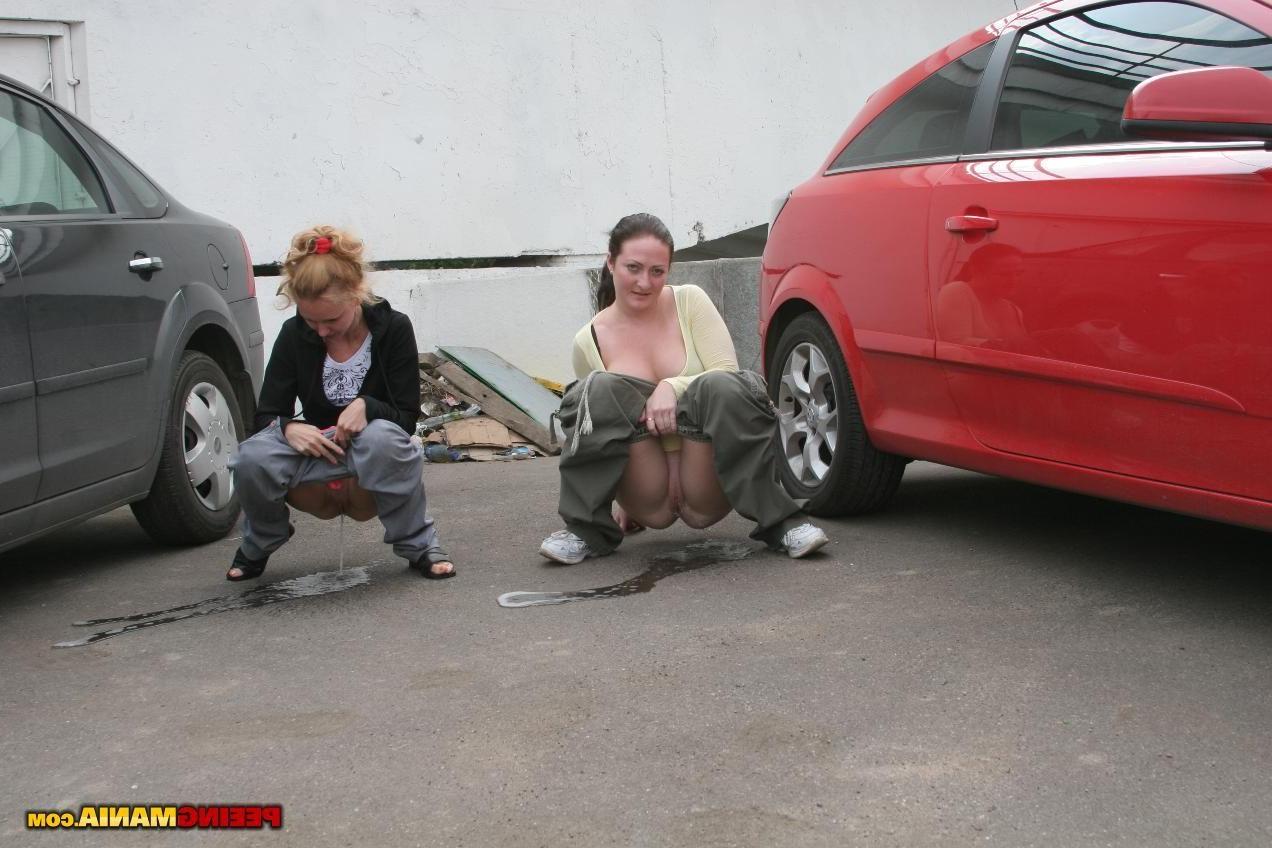 15P A couple of nasty squatted gals empty their bladders among the cars