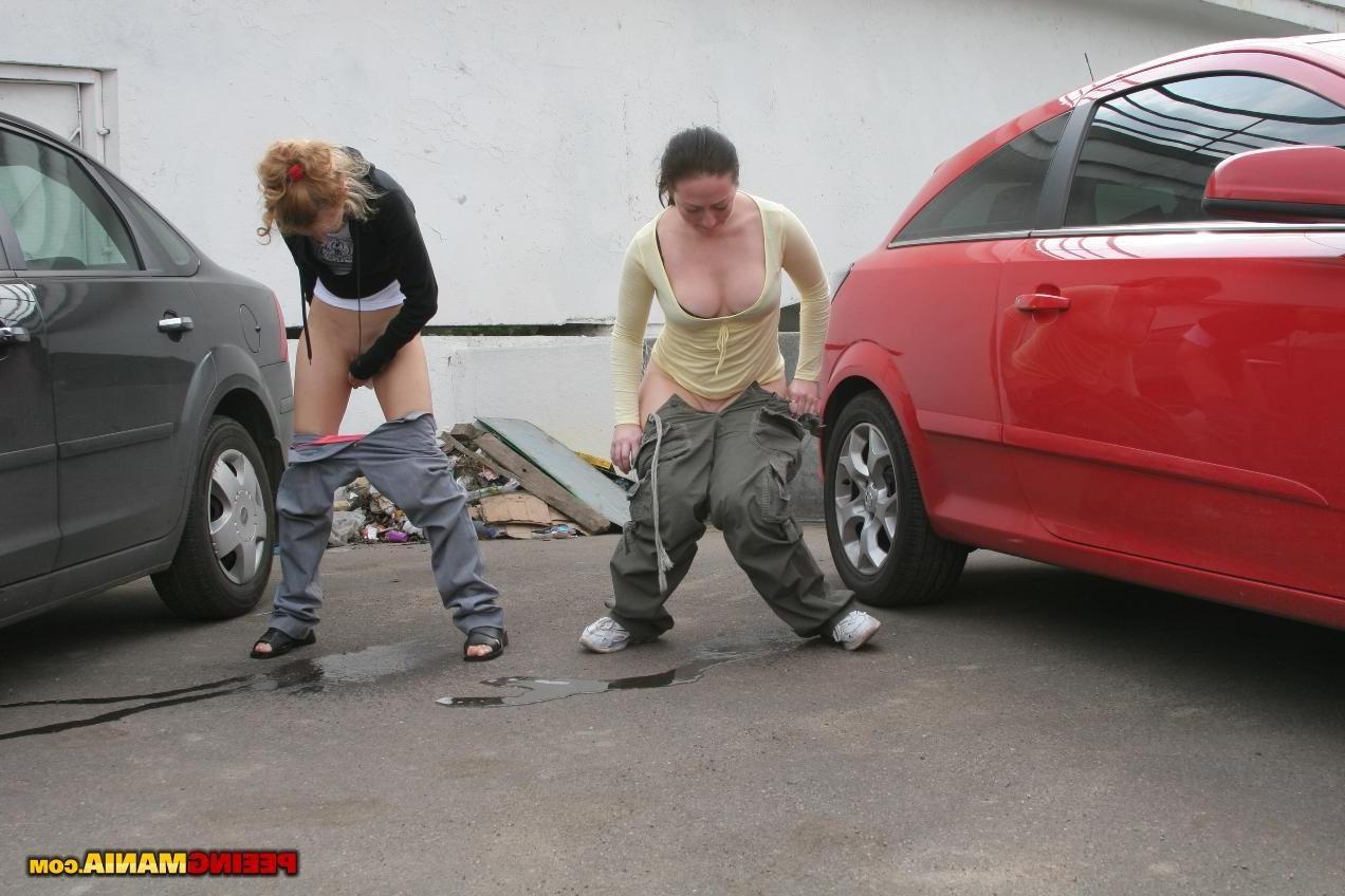 15P A couple of nasty squatted gals empty their bladders among the cars