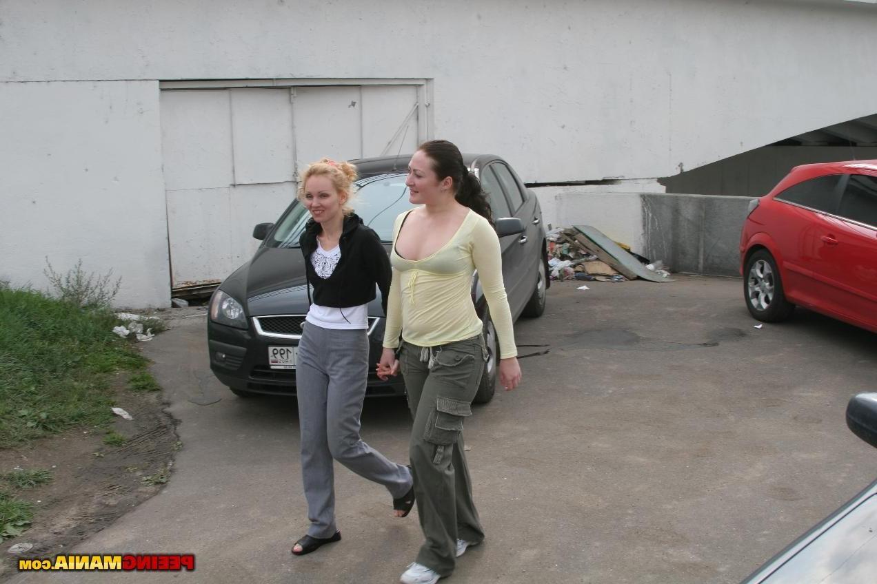 15P A couple of nasty squatted gals empty their bladders among the cars
