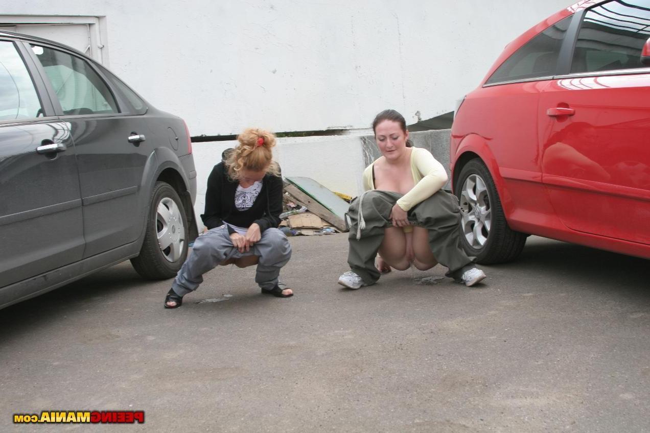 15P A couple of nasty squatted gals empty their bladders among the cars