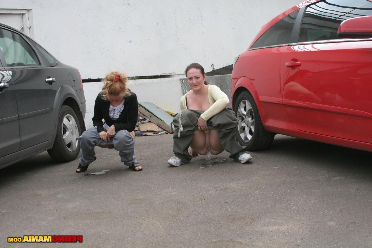 15P A couple of nasty squatted gals empty their bladders among the cars