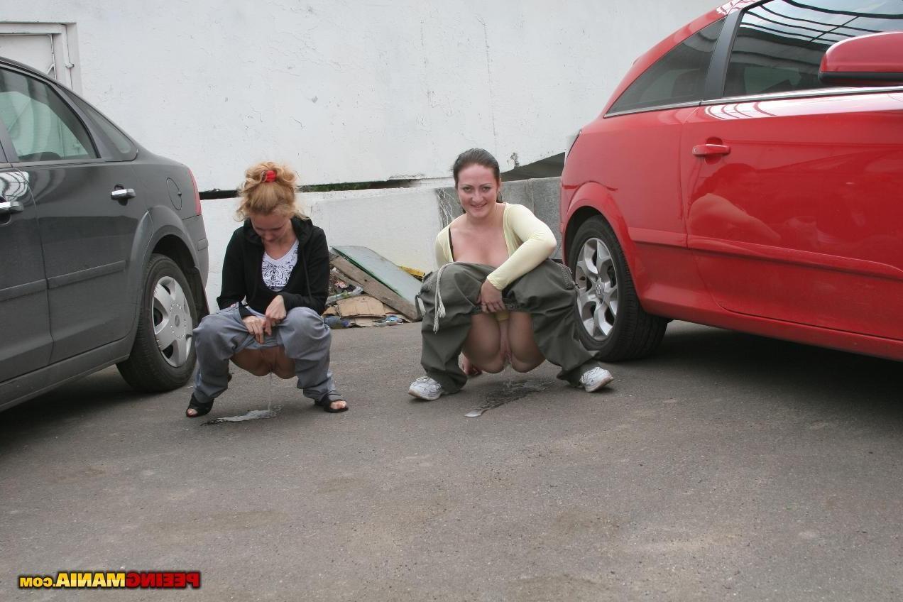 15P A couple of nasty squatted gals empty their bladders among the cars