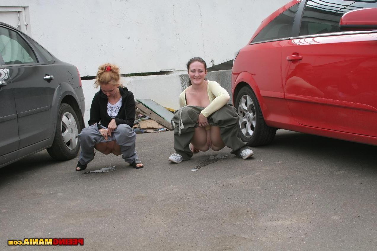 15P A couple of nasty squatted gals empty their bladders among the cars