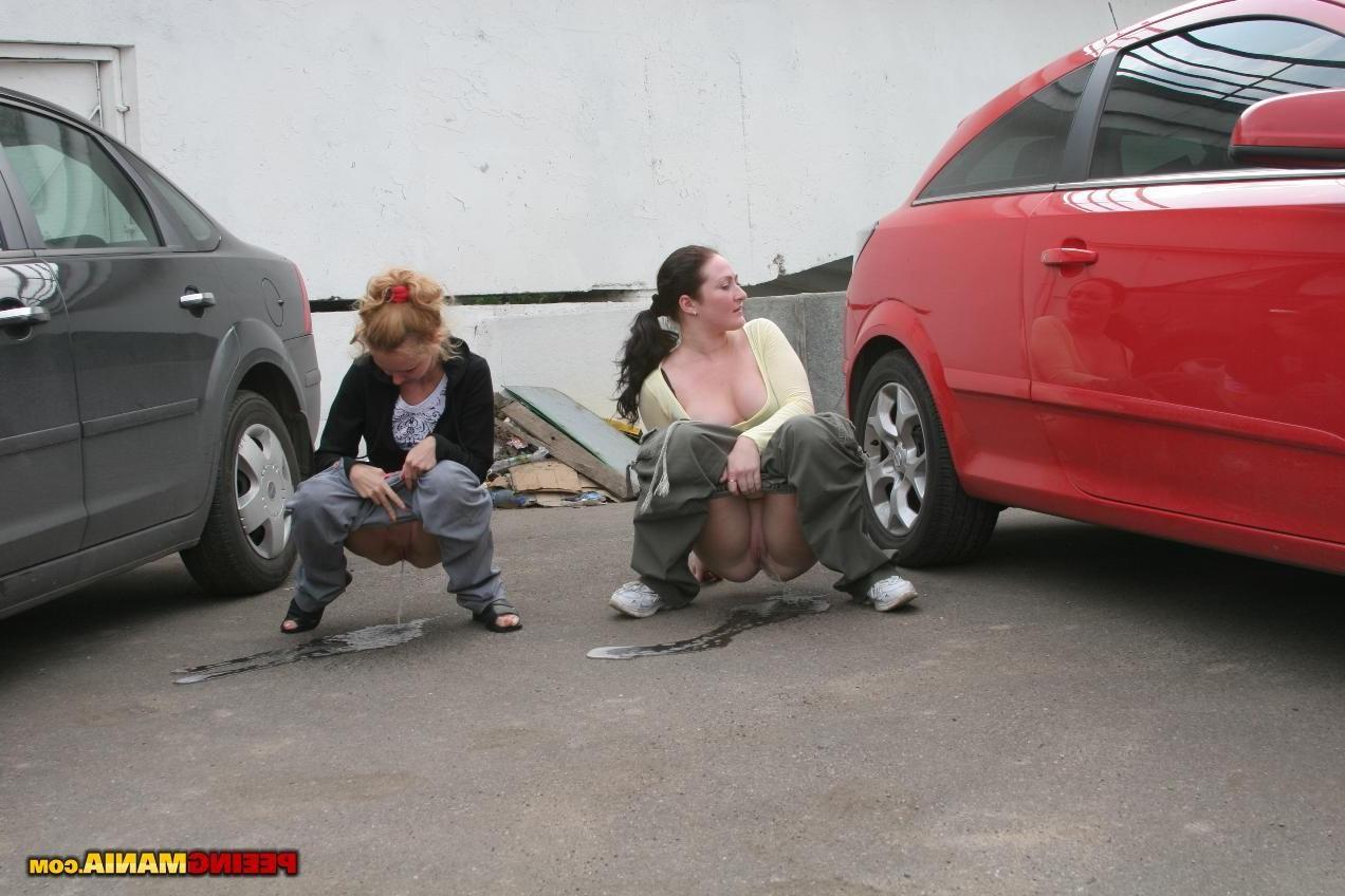 15P A couple of nasty squatted gals empty their bladders among the cars