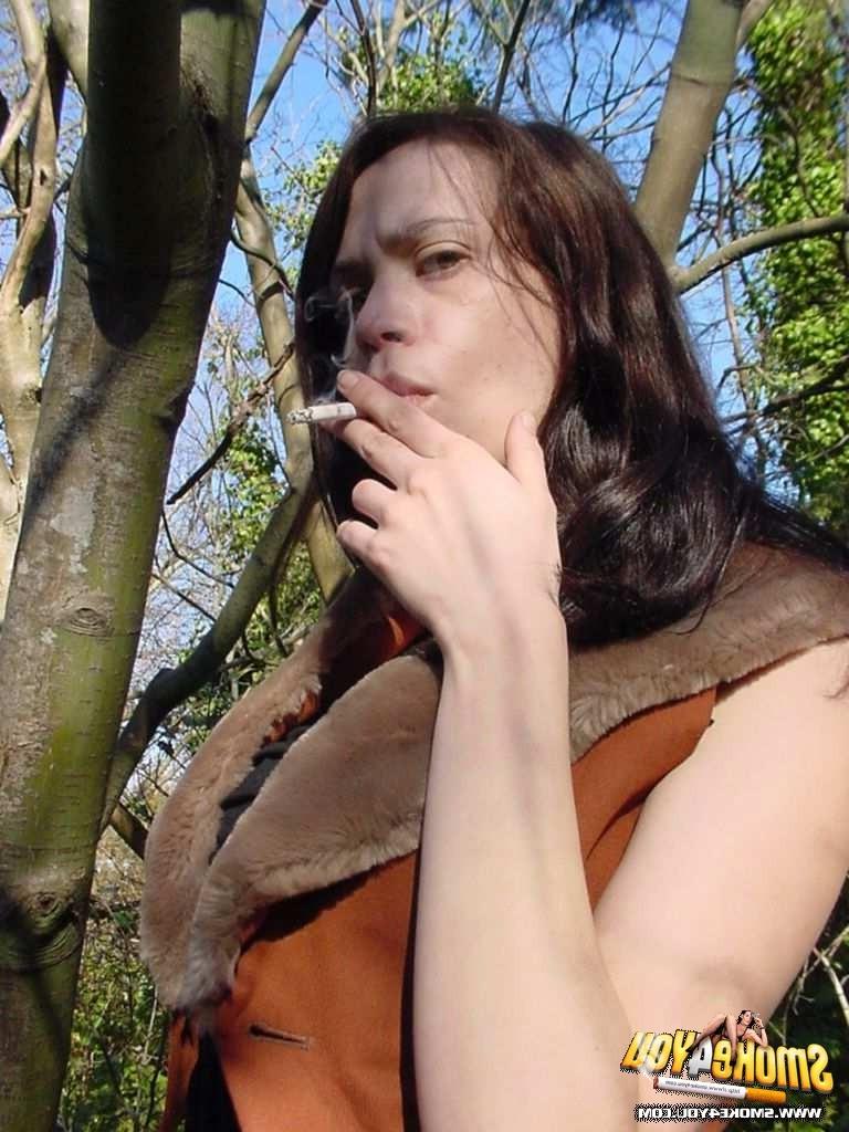 16P Sexy Anita walks through the forest puffing her cigarette