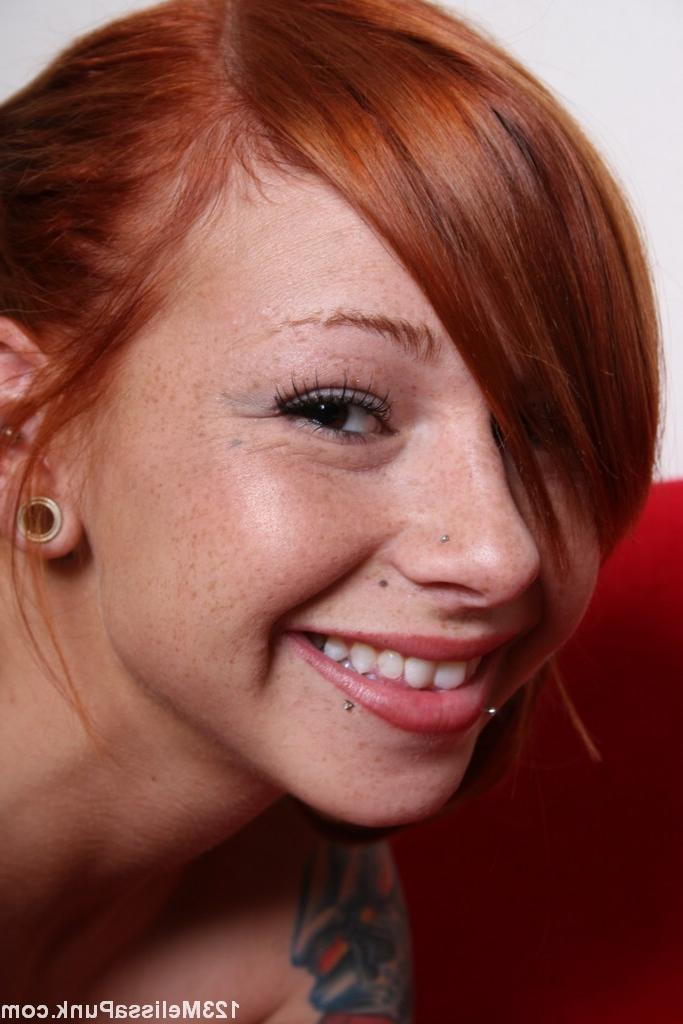 18P Busty redhead babe with lots of tattoos and piercings