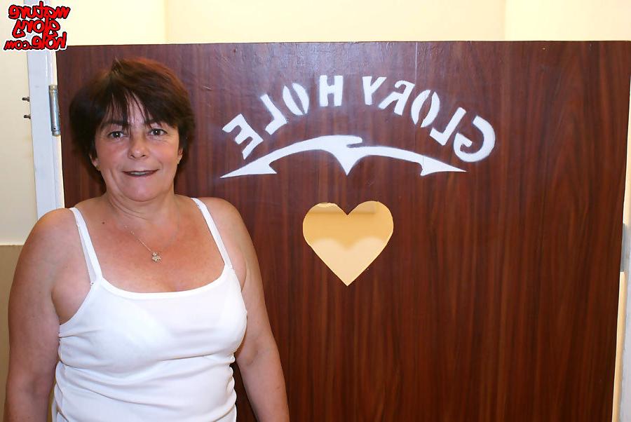 16P big boobed granny sucking a big black cock at a glory hole