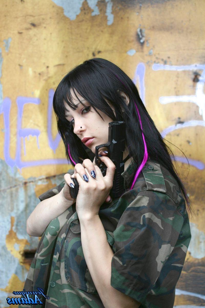 15P Jennique Adams holds a gun while showing her juggs