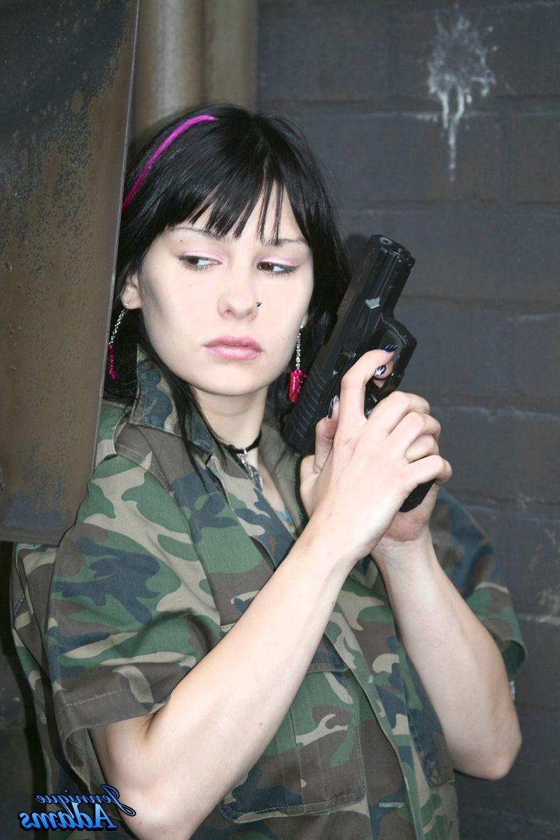 15P Jennique Adams holds a gun while showing her juggs