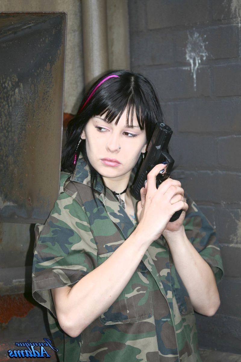 15P Jennique Adams holds a gun while showing her juggs