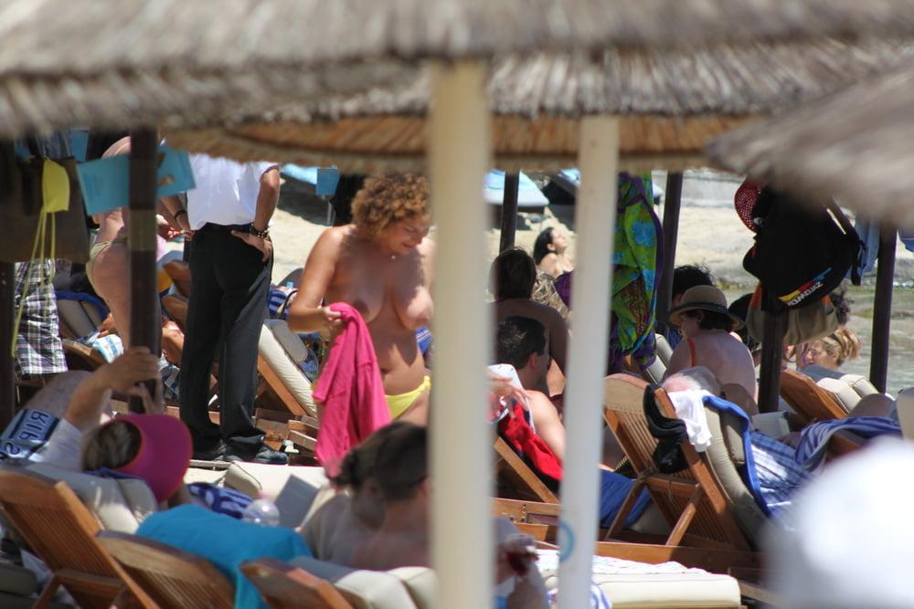 9P Girl with curly hair big tits and areola topless Mykonos