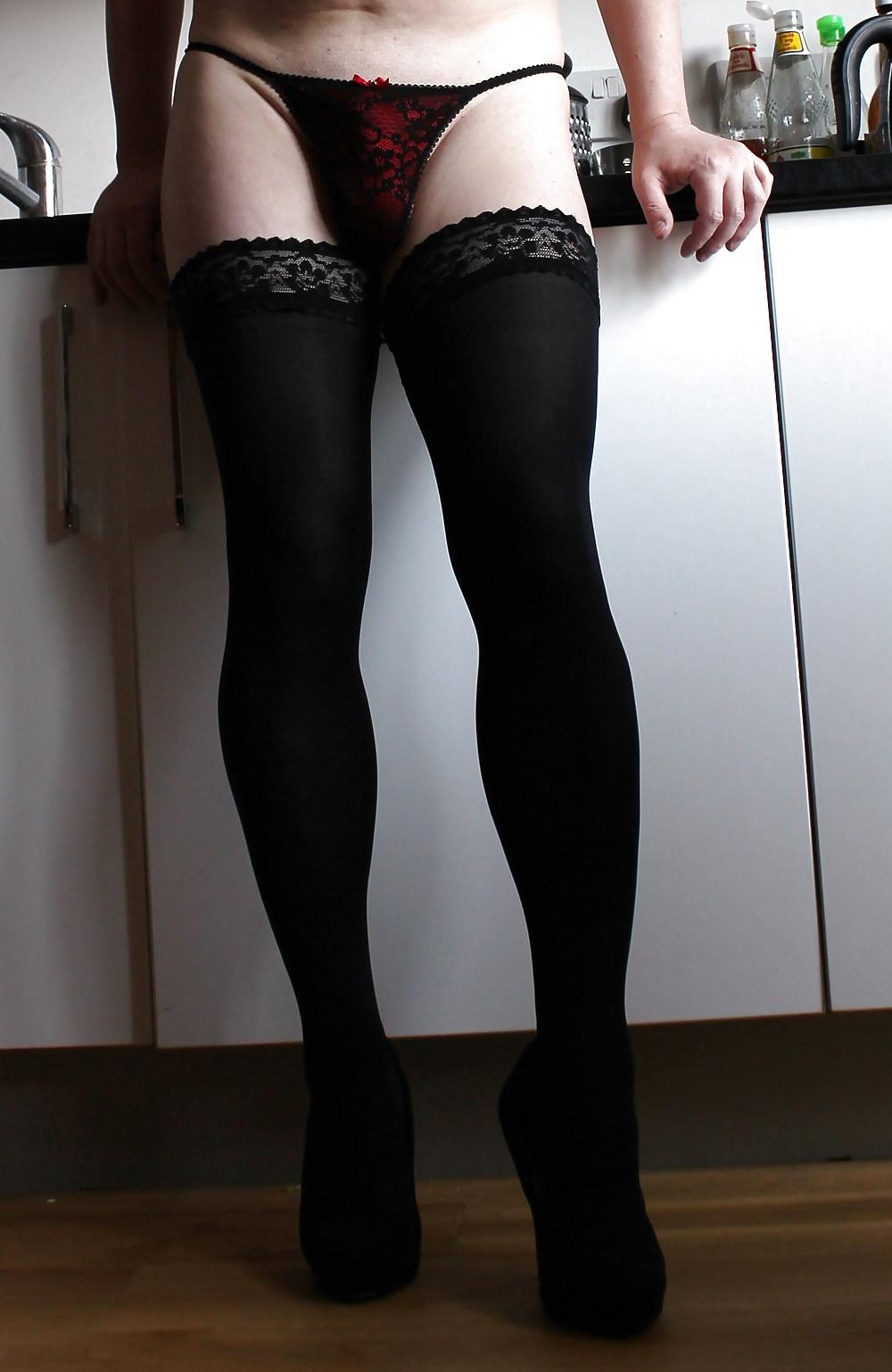 20P Emma Lee in the kitchen wearing black stockings and thong
