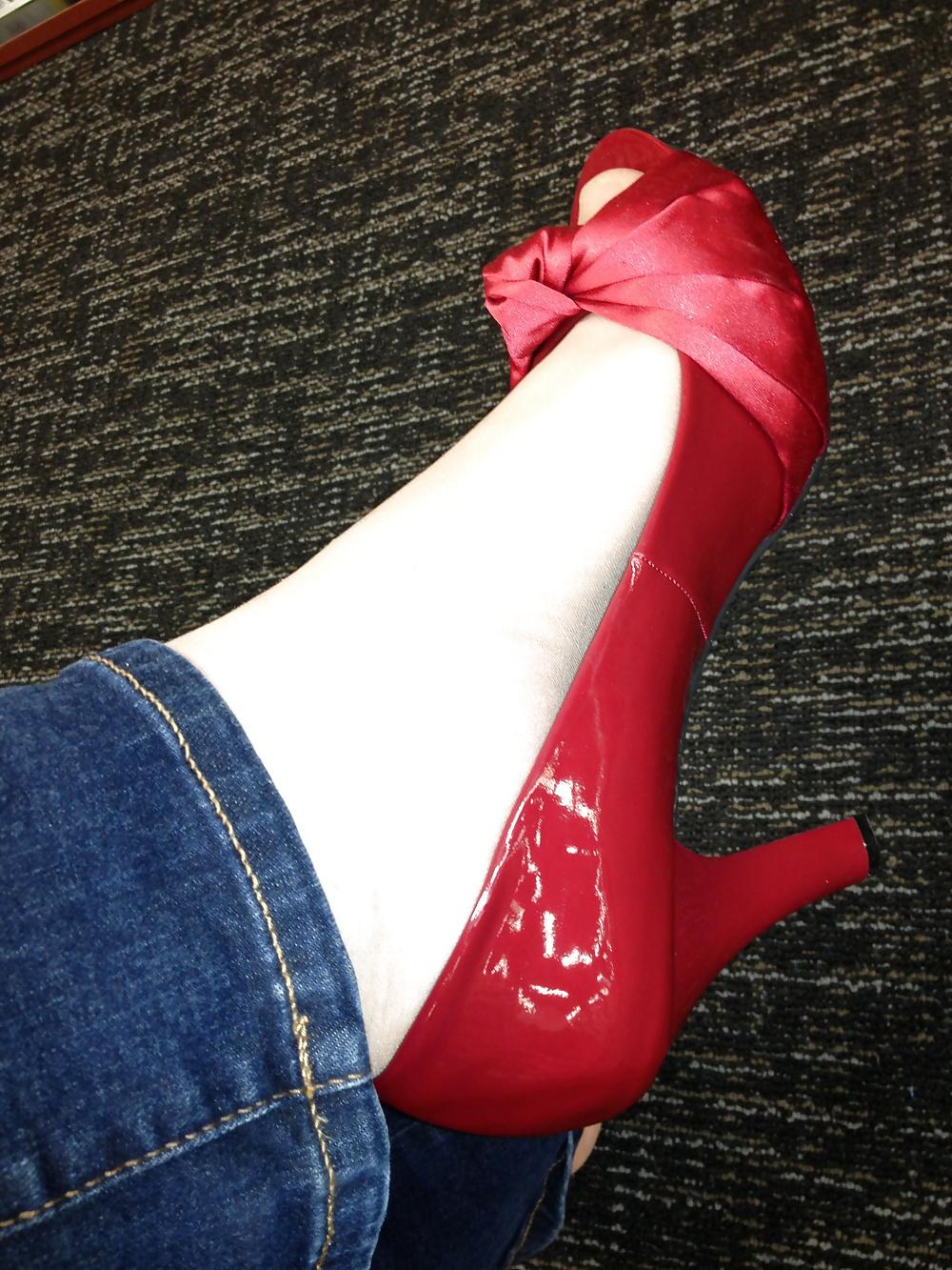 13P Stocking feet trying on red heels in shoe store