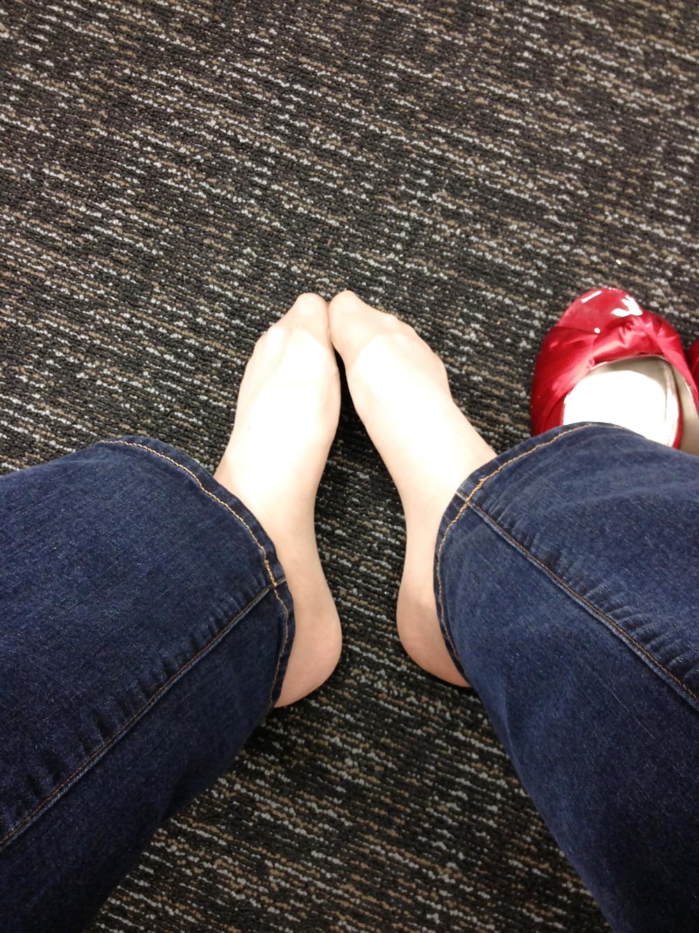 13P Stocking feet trying on red heels in shoe store