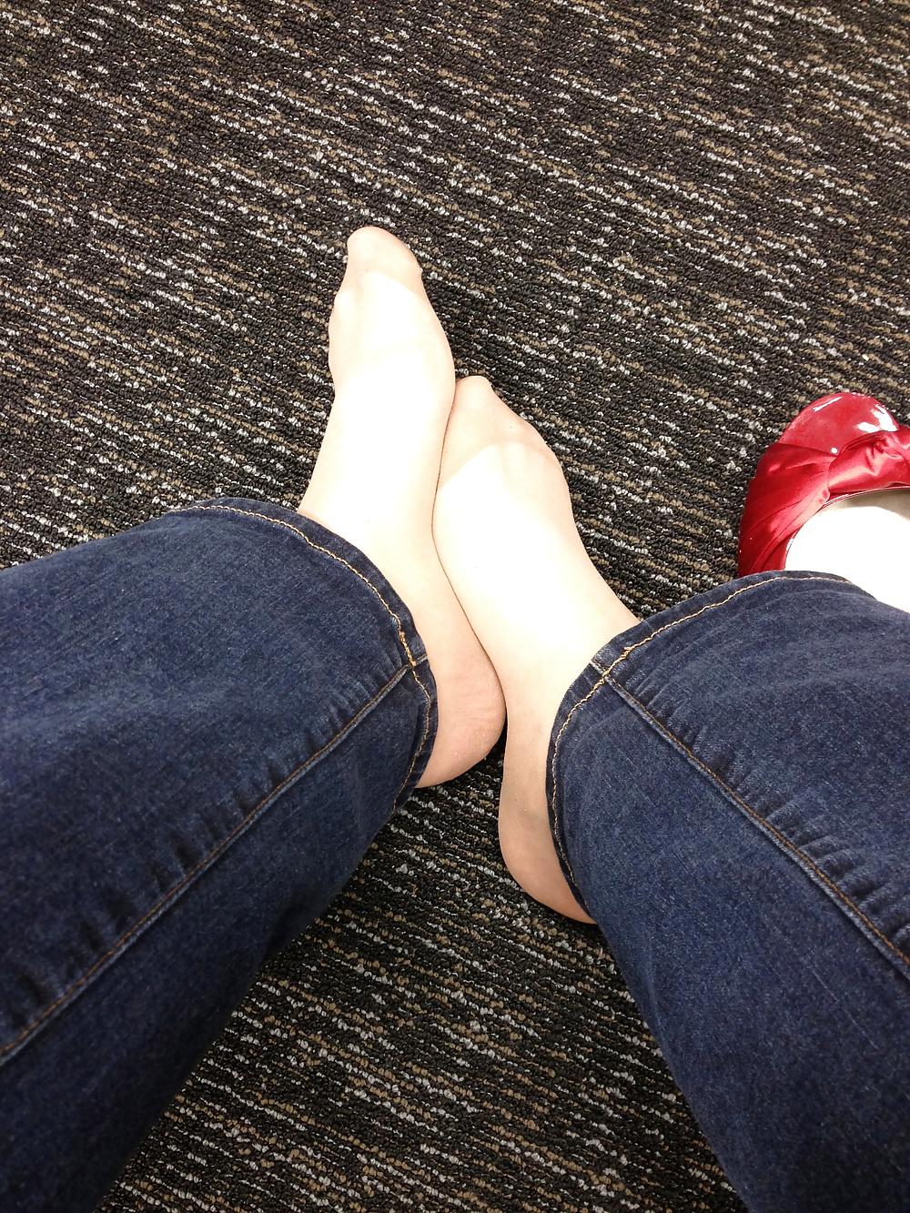 13P Stocking feet trying on red heels in shoe store