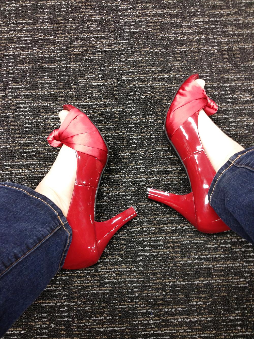 13P Stocking feet trying on red heels in shoe store