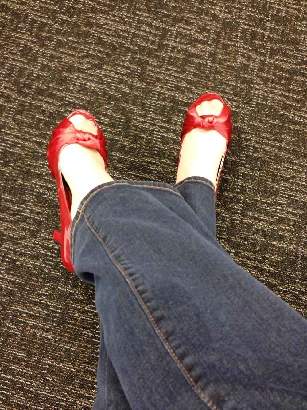 13P Stocking feet trying on red heels in shoe store