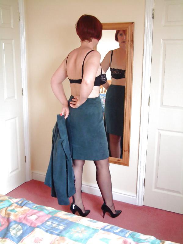 25P Amateur redhead lady strips slowly