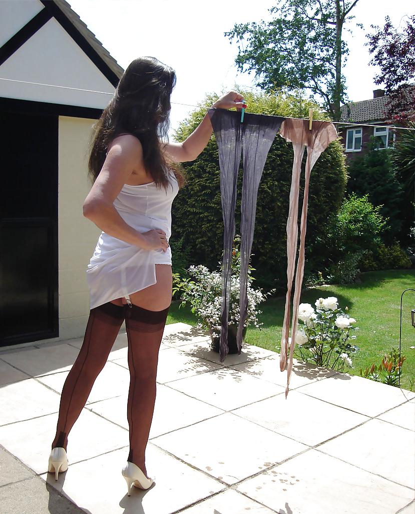 13P Strong lady in slip hangs washing
