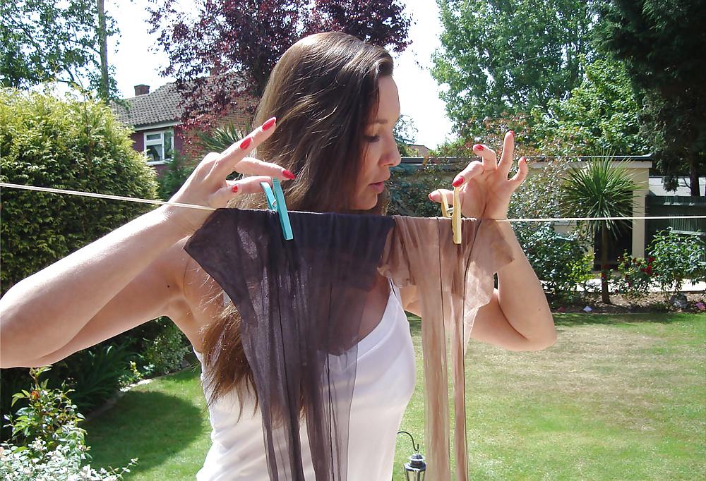 13P Strong lady in slip hangs washing