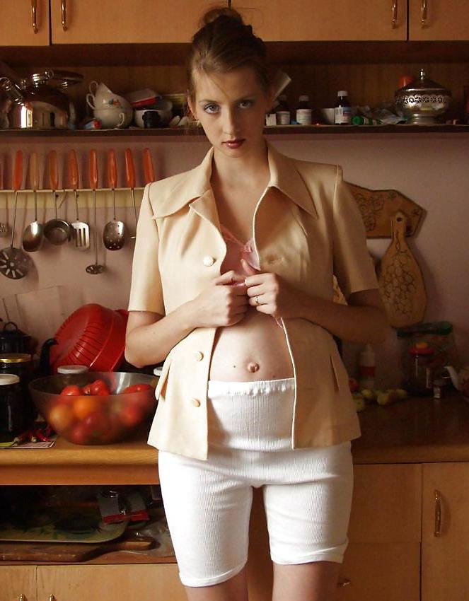 15P Pretty pregnant brunette in the kitchen