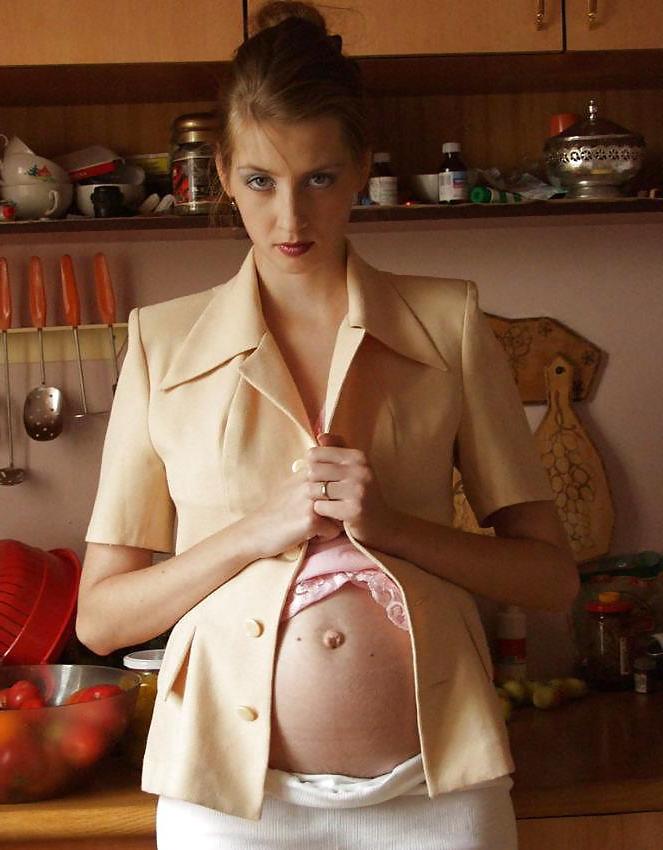 15P Pretty pregnant brunette in the kitchen